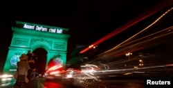 The Arc de Triomphe is illuminated in green with the words "Paris Agreement is Done," to celebrate the Paris U.N. COP21 Climate Change agreement in Paris, France, Nov. 4, 2016.