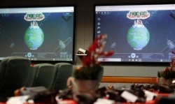 FILE - Monitors are illuminated in the NORAD Tracks Santa center at Peterson Air Force Base, Monday, Dec. 23, 2019, in Colorado Springs, Colo.