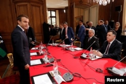 French President Macron (L) attends a meeting with Libyan Prime Minister Fayez al-Sarraj (R) and General Khalifa Haftar (2ndR), commander in the Libyan National Army (LNA) in La Celle-Saint-Cloud, France, July 25, 2017.
