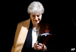 British Prime Minister Theresa May leaves 10 Downing Street in London to take questions at the Houses of Parliament, April 19, 2017.