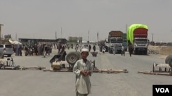A boy stands at the closed Chaman border crossing between Pakistan and Afghanistan with trucks seen stranded in the background. Pakistan closed its two main border crossings with Afghanistan in response to this Thursday's terror attack in a remote town in Sindh province, the deadliest in the country in more than three years.