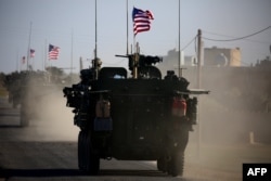 A convoy of U.S. forces armored vehicles drives near the village of Yalanli, on the western outskirts of the northern Syrian city of Manbij, March 5, 2017.