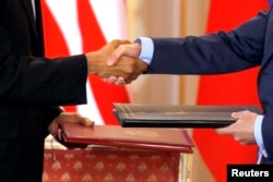 Presiden AS Barack Obama dan Presiden Rusia Dmitry Medvedev berjabat tangan saat melakukan serah terima Perjanjian Pengurangan Senjata Strategis (START II) baru yang ditandatangani di Kastil Praha di Praha, 8 April 2010. (REUTERS/Petr Josek)