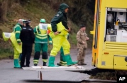 FILE - Military forces work on a van in Winterslow, England, March 12, 2018, as investigations continue into the nerve-agent poisoning of Russian former spy Sergei Skripal and his daughter, Yulia, in Salisbury, England, March 4,2018.