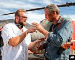 Co-writer/director Joe Carnahan reviews a scene with Liam Neeson on the set of The A-Team