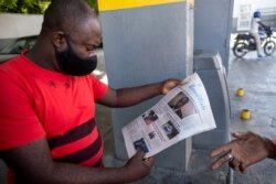 A man reads the front page of a local newspaper with the news of the assassination of President Jovenel Moise, in Port-au-Prince, Haiti, July 10, 2021.