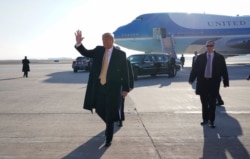 FILE - President Donald Trump waves to supporters upon his arrival in Colorado Springs, Colorado.