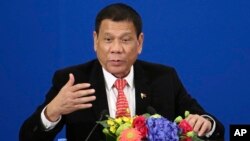 FILE - Philippine President Rodrigo Duterte delivers a speech during the Philippines-China Trade and Investment Forum at the Great Hall of the People in Beijing, Oct. 20, 2016. 