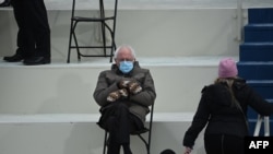 FILE - Senator Bernie Sanders, D-Vermont, sits in the bleachers on Capitol Hill before Joe Biden is sworn in as the 46th US President at the US Capitol in Washington, Jan. 20, 2021.