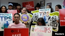 FILE - People gather during a news conference at the New York Immigration Coalition following U.S. President Donald Trump's announcement to end the Temporary Protection Status for Salvadoran immigrants in Manhattan, New York, Jan. 8, 2018.
