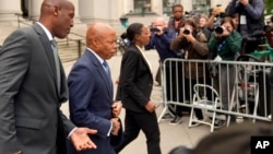 FILE - New York City Mayor Eric Adams, second from left, leaves the courthouse in New York, Oct. 2, 2024. 