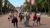 People photograph workers putting up U.S. flags along The Mall towards Buckingham Palace in central London ahead of U.S. President Donald Trump state visit to Britain, London, Britain, June 2, 2019.