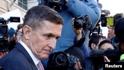 Former U.S. national security adviser Michael Flynn passes by members of the media as he departs after his sentencing was delayed at U.S. District Court in Washington, Dec. 18, 2018. 
