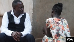 Caleb Ng'ombo, director of People Serving Girls at Risk, talks to "Maggie" a victim of child trafficking, in Neno district in southern Malawi.