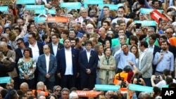 Catalan President Carles Puigdemont, second row ,center, takes part at a march to protest against the National Court's decision to imprison civil society leaders, in Barcelona, Spain, Saturday, Oct. 21, 2017. (AP Photo/Emilio Morenatti)