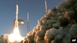 FILE - A rocket lifts off at the Cape Canaveral Air Force Station in Cape Canaveral, Fla., July 30, 2020.