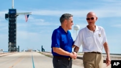 In this July 16, 2019 photo made available by NASA, astronaut Michael Collins, right, speaks to Kennedy Space Center Director Bob Cabana at Launch Complex 39A, about the moments leading up to launch at 9:32 a.m. on July 16, 1969.