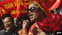 File - Bui Thi Minh Hang (R), during an anti-China protest in downtown Hanoi on July 24, 2011. 