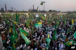 Supporters of Pakistan's former Prime Minister Nawaz Sharif attend a welcoming rally for their leader in his native Lahore, Pakistan, on Oct. 21, 2023.