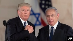 FILE - President Donald Trump, left, and Israeli Prime Minister Benjamin Netanyahu shake hands at the Israel museum in Jerusalem, May 23, 2017. 