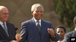 President Nelson Mandela dances at a celebration concert following his inauguration at the Union Buildings in Pretoria, South Africa, May 10, 1994.