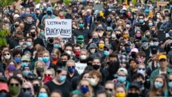 Protesters Sing "We Shall Overcome" as Officer Charges Amended