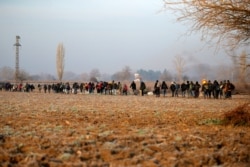 Migrants walk to reach Pazarakule border gate, Edirne, Turkey, at the Turkish-Greek border on March 1, 2020.