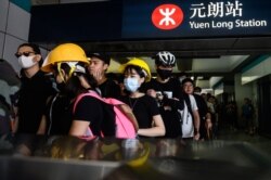 Protesters line up inside an MTR station in the Yuen Long district of Hong Kong, July 27, 2019, before an expected protest march in the afternoon.