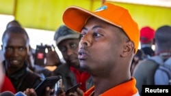 FILE - Rwandan singer Kizito Mihigo talking to reporters after his release from prison, in Kigali, Sept. 15, 2018. 