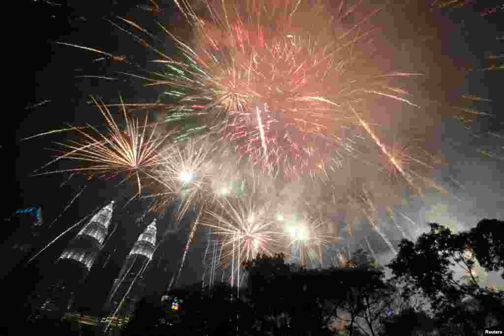 Fireworks explode near Petronas Twin Towers during New Year celebrations in Kuala Lumpur, Malaysia, Jan. 1, 2019.