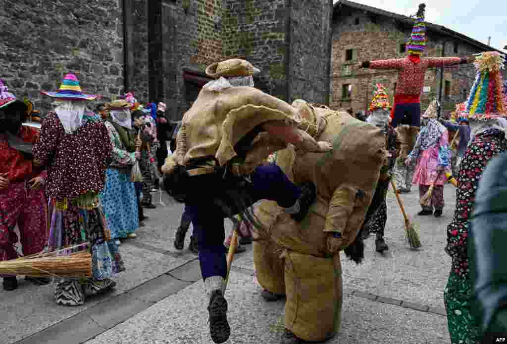 "Zaldiko" (man of the horse) hits Ziripot (C) to make him fall down during an ancient carnival in the northern Spanish Navarre village of Lantz, Spain.