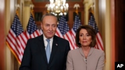 House Speaker Nancy Pelosi, right, and Senate Minority Leader Chuck Schumer pose for photographers after speaking on Capitol Hill in response President Donald Trump's prime-time address on border security, in Washington, Jan. 8, 2019.