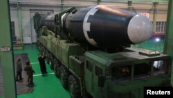 North Korea's leader Kim Jong Un is seen as the newly developed intercontinental ballistic rocket Hwasong-15's test was successfully launched, in this undated photo released by North Korea's Korean Central News Agency in Pyongyang, Nov. 30, 2017.