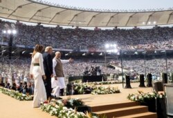 U.S. President Donald Trump, first lady Melania Trump, and Indian Prime Minister Narendra Modi arrive for a "Namaste Trump," event at Sardar Patel Stadium, Feb. 24, 2020, in Ahmedabad, India.