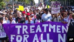 FILE - Civil rights activists march in Durban, South Africa, July 18, 2016 at the start of the 21st World Aids Conference to demand that the fight against HIV/Aids be continued and that funding in the fight against the disease must not be cut. 