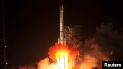 FILE - The Long March-3B rocket carrying the Chang'e-3 lunar probe blasts off from the launch pad at Xichang Satellite Launch Center, Sichuan province, in the early morning hours, Dec. 2, 2013. 