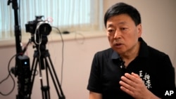 FILE- Wang Zhi'an speaks during an interview with the Associated Press in Tokyo on Oct. 5, 2022. Wang, as well as artist-turned-dissident Li Ying, said in separate posts Feb. 25, 2024, that police were interrogating people who followed them on social media.
