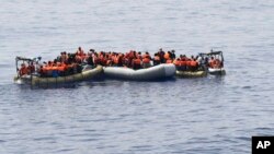 This undated image made available on May 30, 2016 by the Italian Navy Marina Militare shows migrants being rescued at sea. Survivor accounts have pushed to more than 700 the number of migrants feared dead in Mediterranean Sea shipwrecks over three days in the past week, even as rescue ships saved thousands of others in daring operations. 