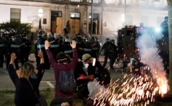 Police push back protesters outside the Kenosha County Courthouse, Aug. 24, 2020, in Kenosha, Wisconsin. Protesters converged on the courthouse during a second night of clashes after the police shooting of Jacob Blake a day earlier.