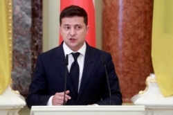 FILE - Ukrainian President Volodymyr Zelensky speaks during a news briefing in Kyiv, Ukraine, Oct. 12, 2020.