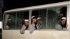 FILE - Newly freed Taliban prisoners are seen inside a bus at Bagram prison, north of Kabul, Afghanistan, April 11, 2020.