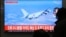 People watch a TV screen showing file footage of a Japanese patrol plane during a news program at the Seoul Railway Station in Seoul, South Korea, Jan. 23, 2019. 