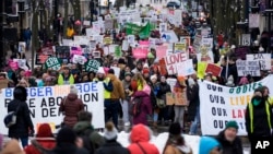 FILE - Protesters make their way to the Wisconsin Capitol Rotunda during a march supporting overturning Wisconsin's near total ban on abortion on Jan. 22, 2023, in Madison, Wisconsin.