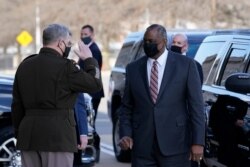 FILE - Defense Secretary Lloyd Austin is saluted by Joint Chiefs Chairman Gen. Mark Milley as he arrives at the Pentagon, Jan. 22, 2021, in Washington.