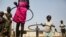 FILE - Children play with hula hoops at a UNICEF site in Juba, South Sudan, on Jan. 15, 2016. A new program to bring teenage mothers back to school is helping the country address the gender gap in education, experts say.
