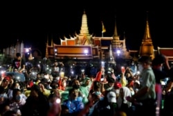 FILE - Pro-democracy protesters light up their mobile phones as they attend a mass rally to call for the ouster of Prime Minister Prayuth Chan-ocha's government and reforms in the monarchy, in Bangkok, Thailand, Sept. 19, 2020.