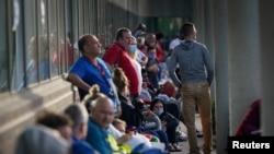 People line up outside Kentucky Career Center prior to its opening to find assistance with their unemployment claims in Frankfort, Kentucky, June 18, 2020.