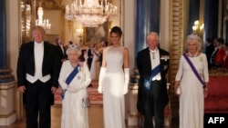 Britain's Queen Elizabeth II (2L), U.S. President Donald Trump (L), First Lady Melania Trump (C), Britain's Prince Charles, Prince of Wales (2R) and Britain's Camilla, Duchess of Cornwall pose for a photograph ahead of a State Banquet at Buckingham Palace, June 3, 2019.