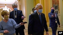 FILE - Senate Republican Majority Leader Mitch McConnell walks past reporters on Capitol Hill in Washington, Dec. 15, 2020. 