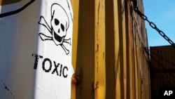 FILE - A sticker reading Toxic on containers carrying Syria's dangerous chemical weapons, on the Danish cargo ship, Ark Futura, transporting the chemical weapons out of the strife-torn country, in Cyprus coastal waters.